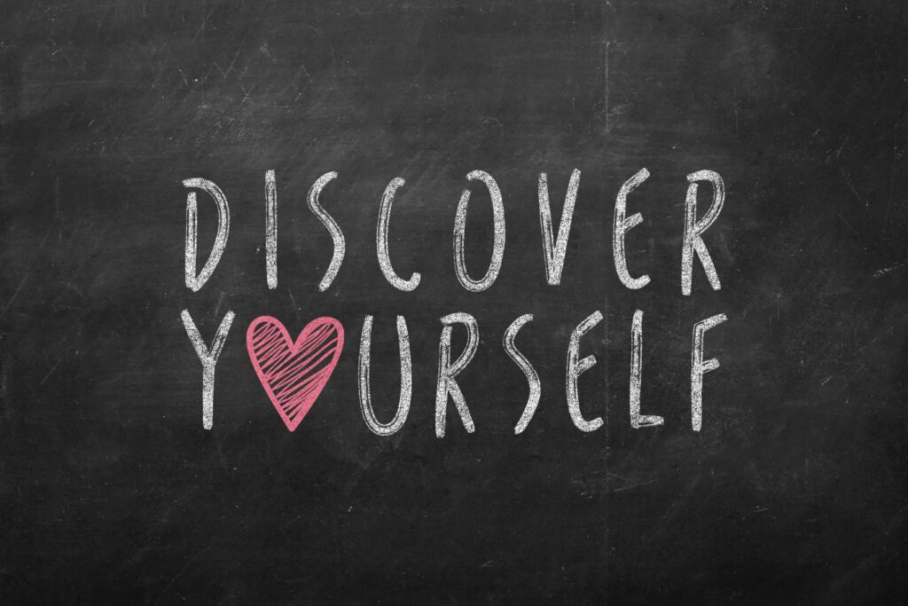 A chalkboard with the words " discover yourself ".